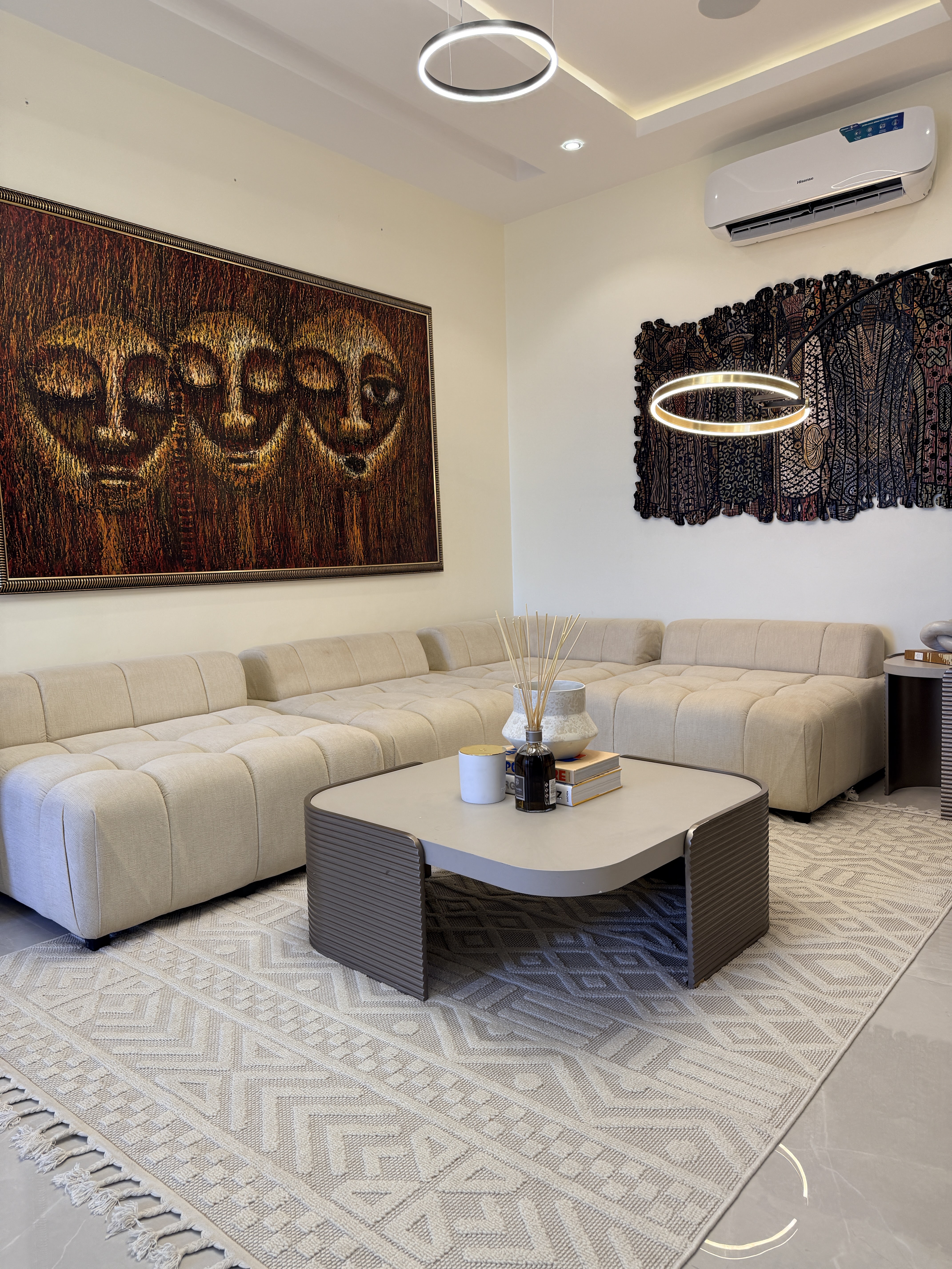 Lounge with art and circular pendant lighting